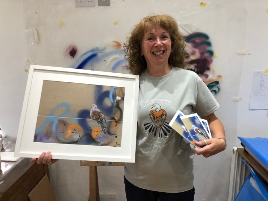  Jo Ruth holding her donated Turtle Dove stencil/graffiti art work 